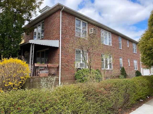 a front view of house with yard and trees around
