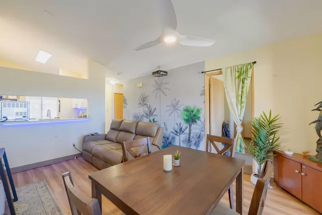 a living room with furniture potted plant and a table