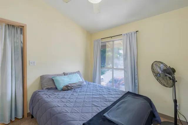 a bedroom with a bed and window