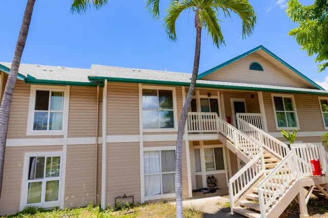 a view of a house with a yard and porch