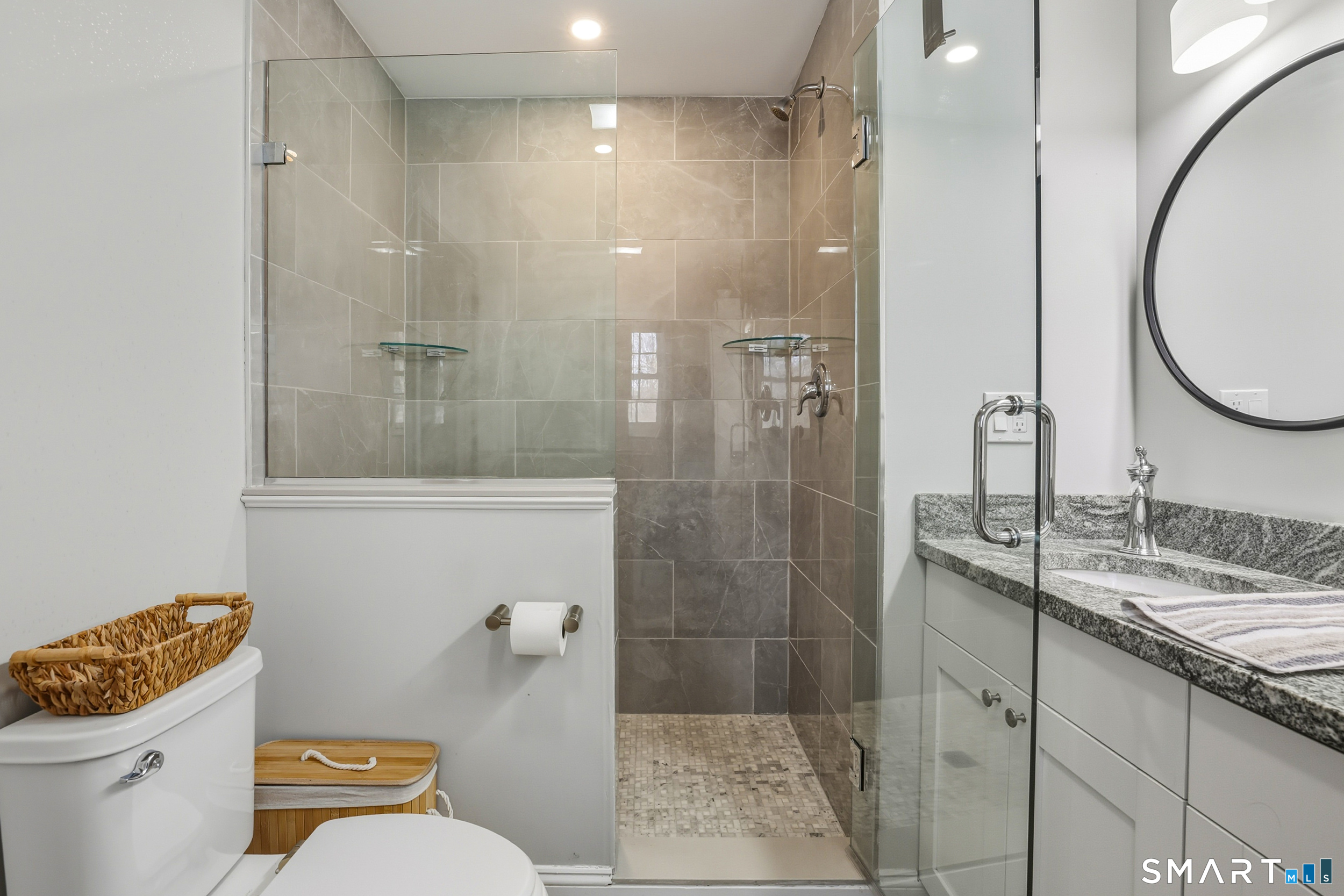 8 Egypt Lane Clinton, CT 06413 - Photo 11 of 33 Master bedroom bath with tile flooring, dual sink vanity, and shower with tile surround and glass enclosure.