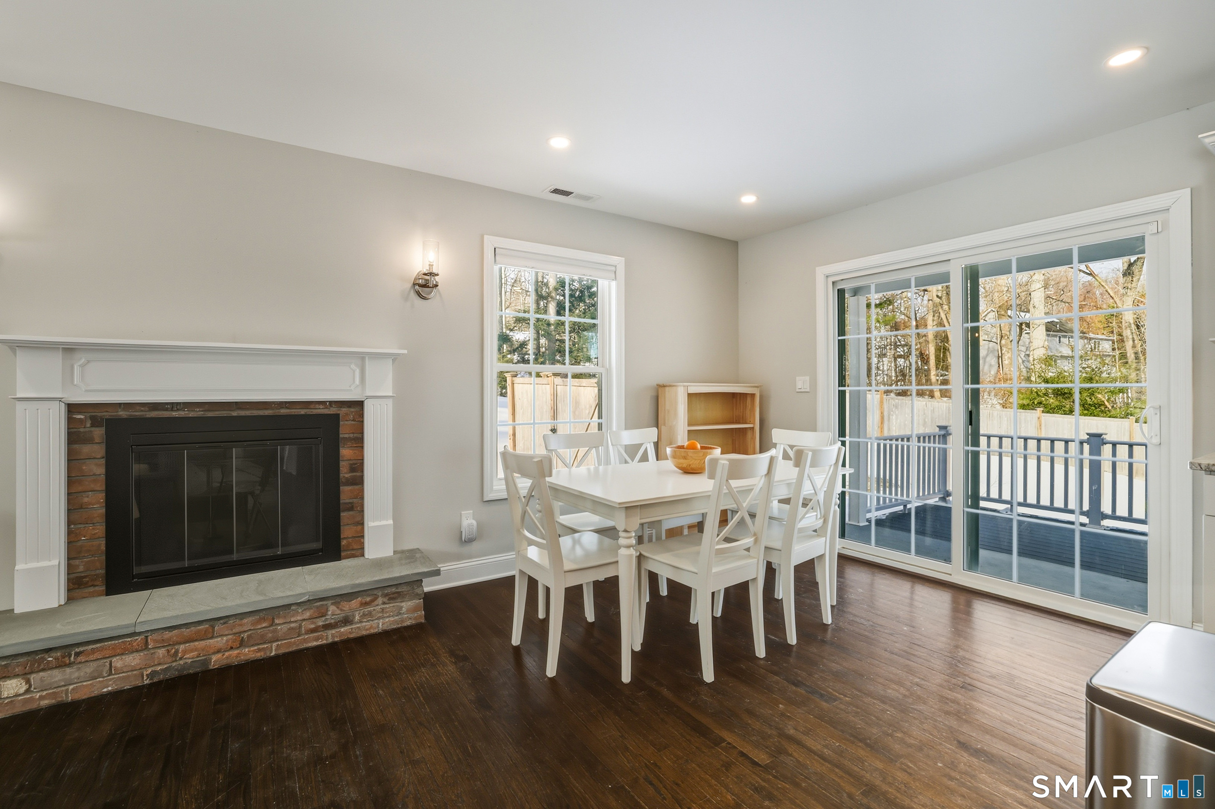 8 Egypt Lane Clinton, CT 06413 - Photo 8 of 33 Living room with wood-burning fireplace. Dining area with sliders leading to a TREX deck.