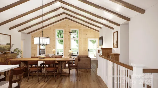 a view of a dining room and livingroom with furniture wooden floor a rug and a chandelier