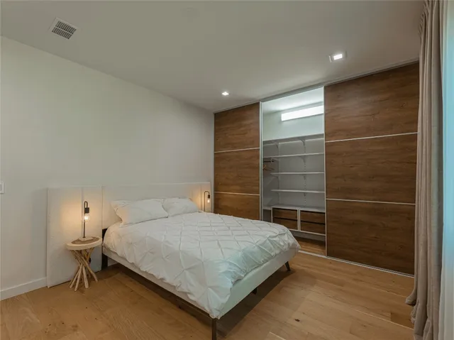 a bedroom with a bed and a desk