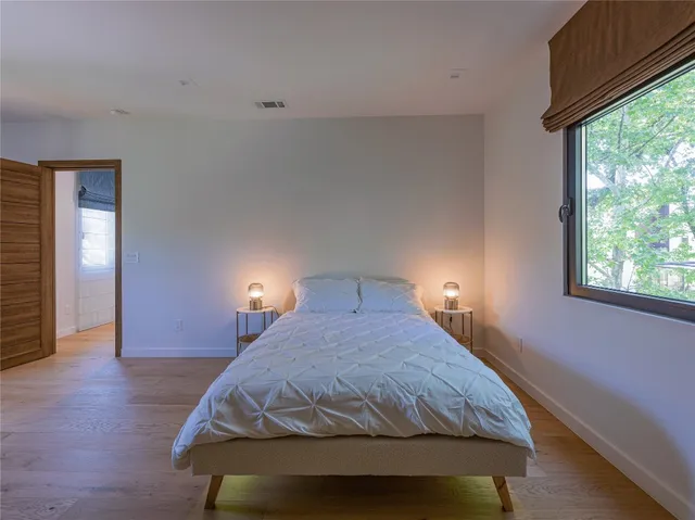 a bedroom with a bed and window