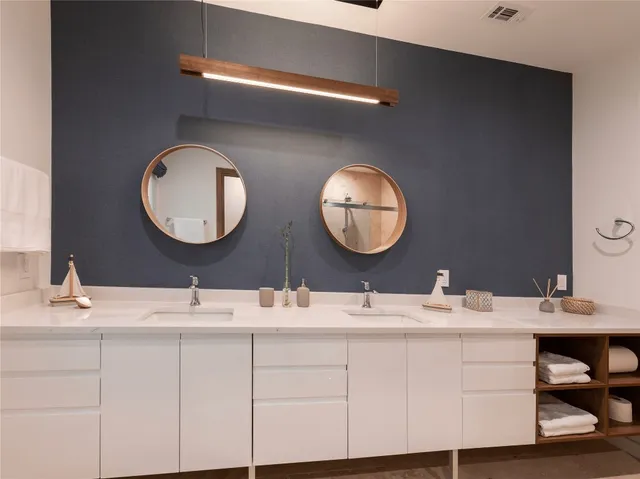 a bathroom with a double vanity sink and a mirror