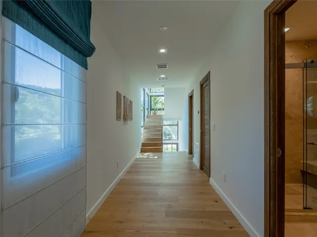 a view of a hallway with wooden floor