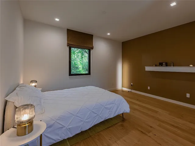 a bedroom with a bed and a lamp