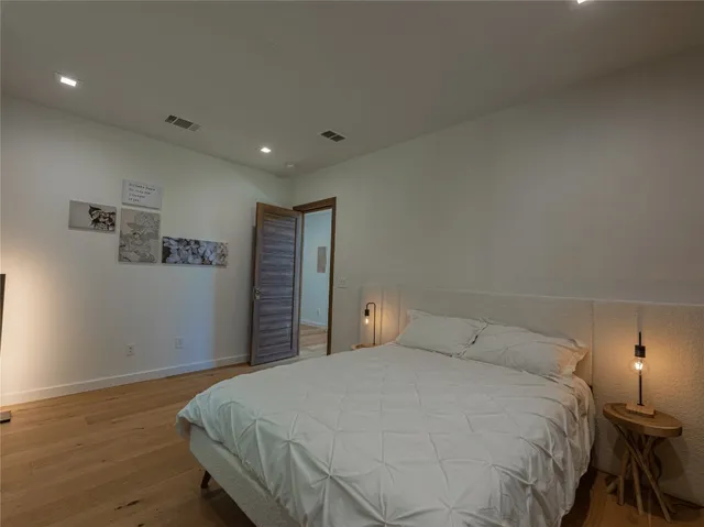 a bedroom with a bed and a night stand