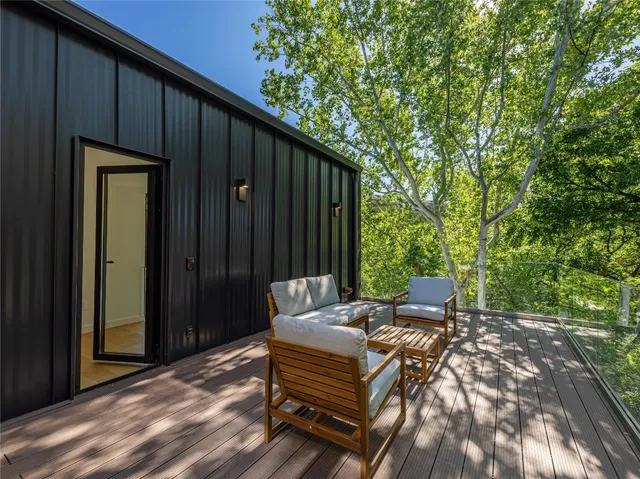 a backyard of a house with table and chairs