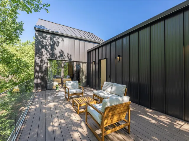 a view of a patio with table and chairs and wooden floor