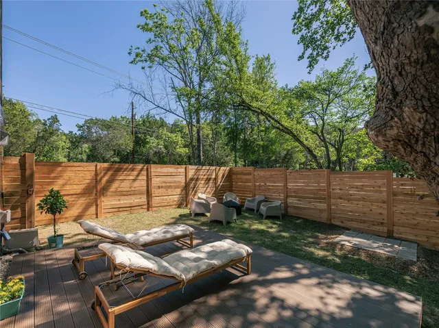 a view of a backyard with chairs and a fire pit