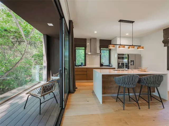 a dining room with furniture a chandelier and wooden floor