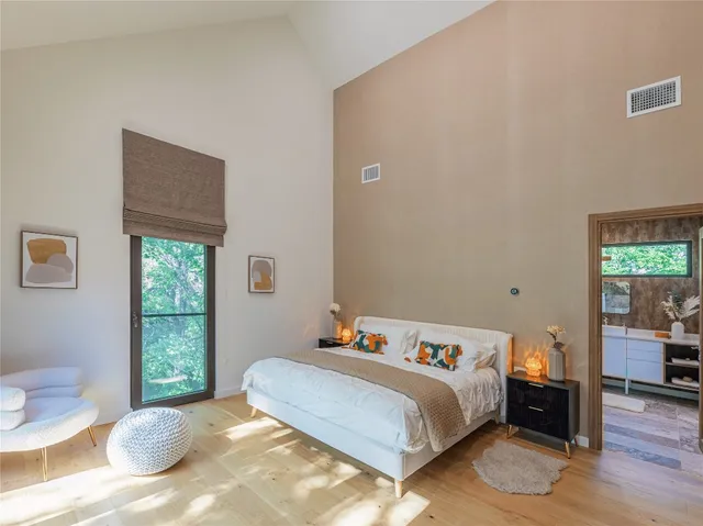 a bedroom with a bed and wooden floor