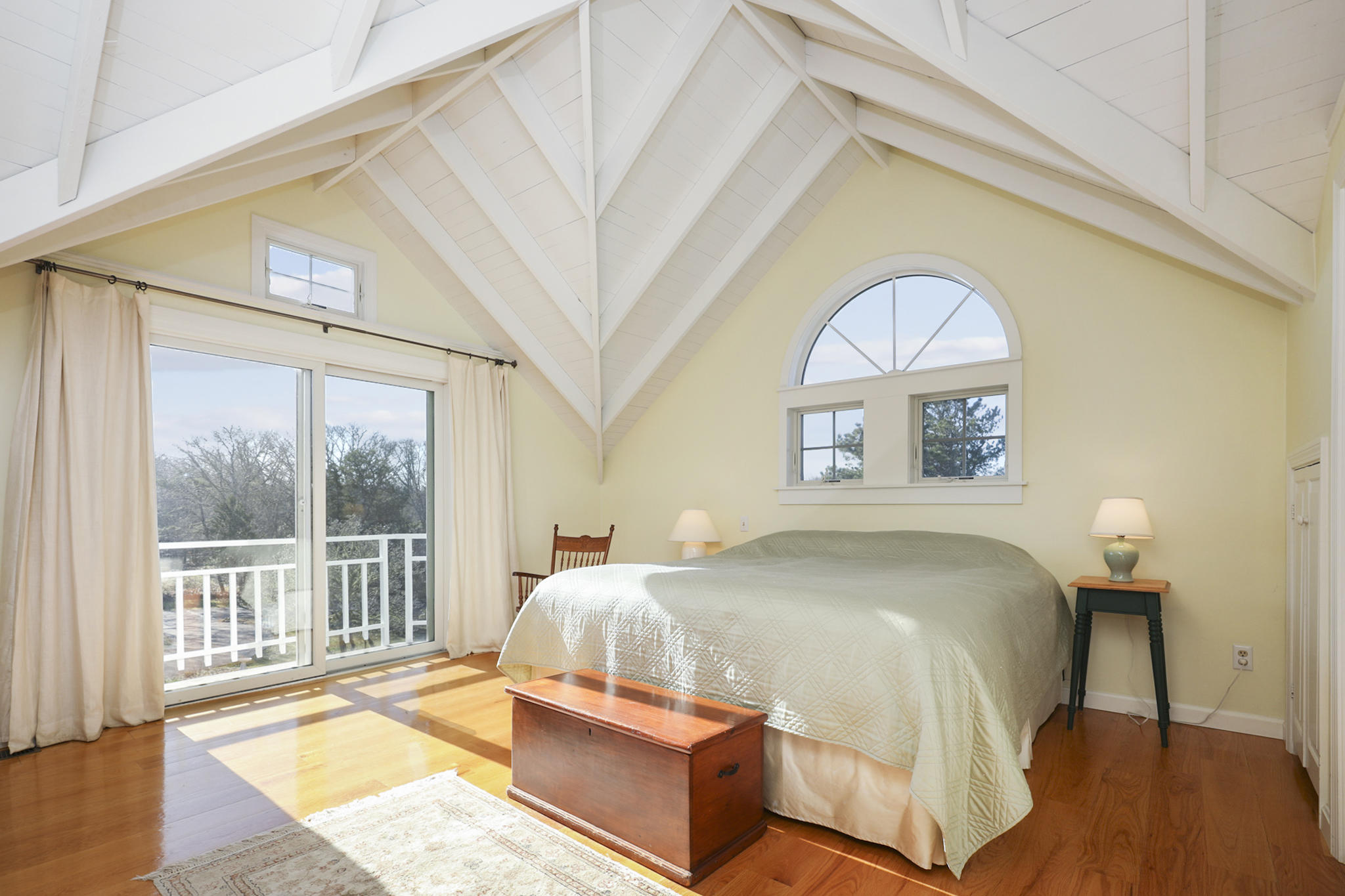 145 Barley Neck Road Orleans, MA 02653 - Photo 15 of 39 a bedroom with a bed and a large window with outer view