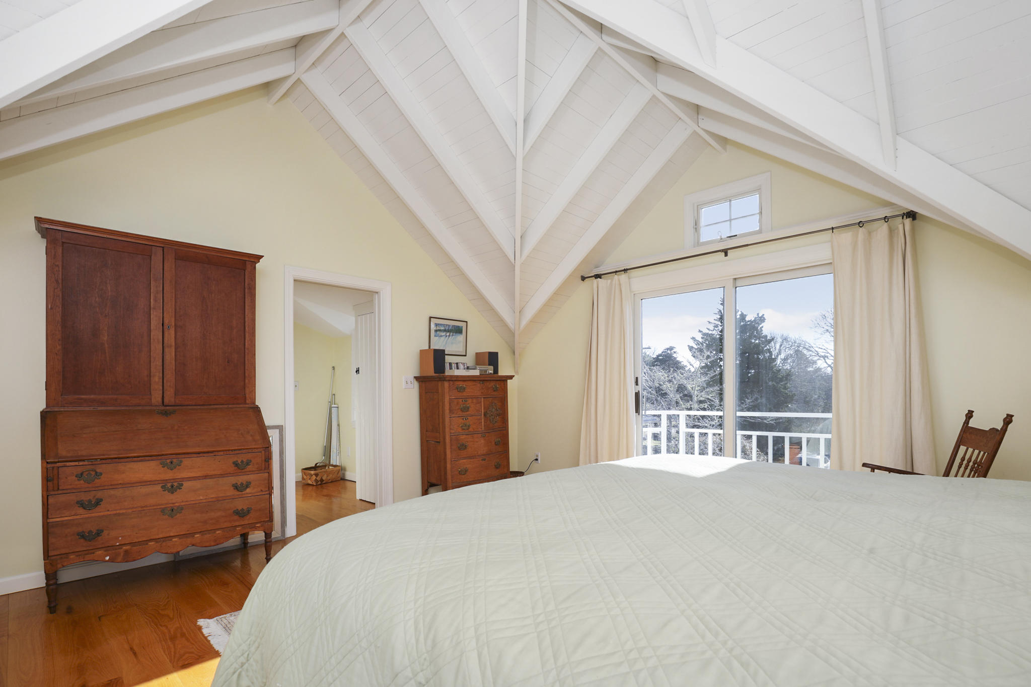 145 Barley Neck Road Orleans, MA 02653 - Photo 16 of 39 a bedroom with a bed and a large window with outer view