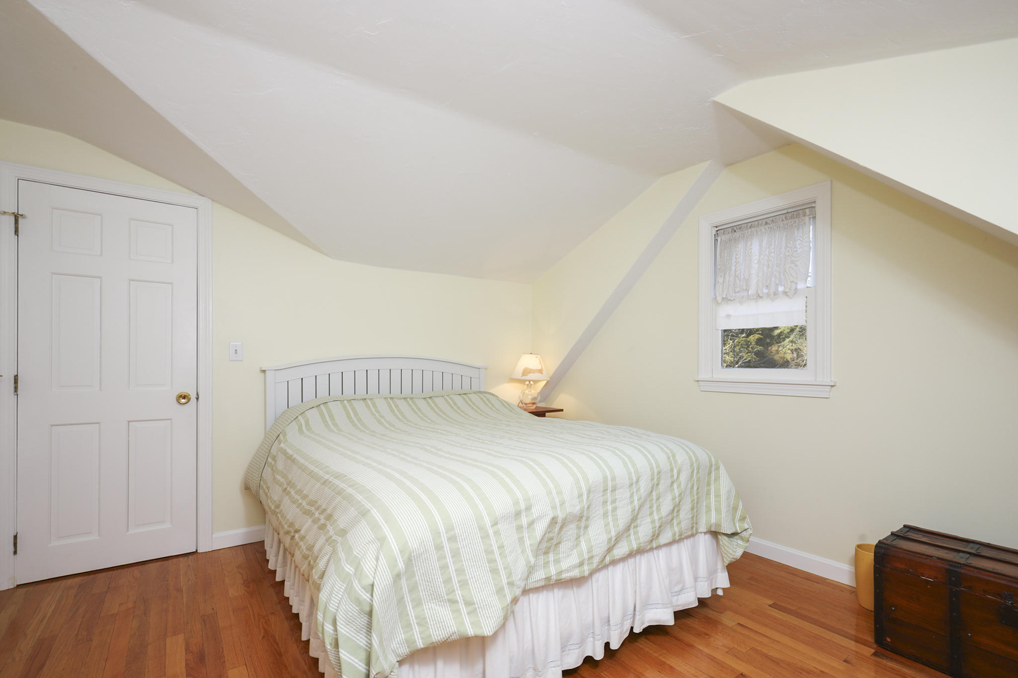 145 Barley Neck Road Orleans, MA 02653 - Photo 22 of 39 a bedroom with a bed and wooden floor