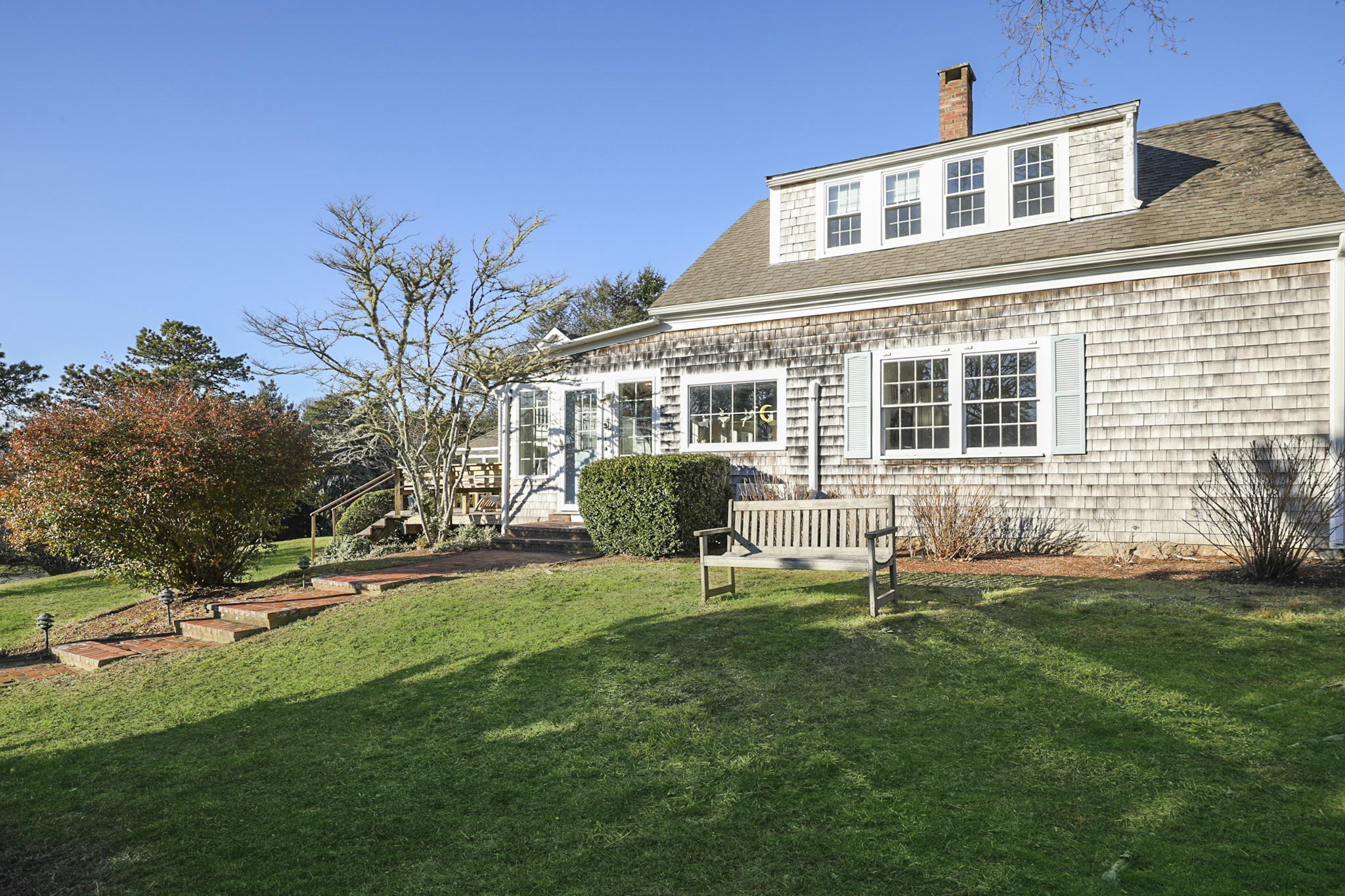 145 Barley Neck Road Orleans, MA 02653 - Photo 33 of 39 a front view of a house with a garden and patio