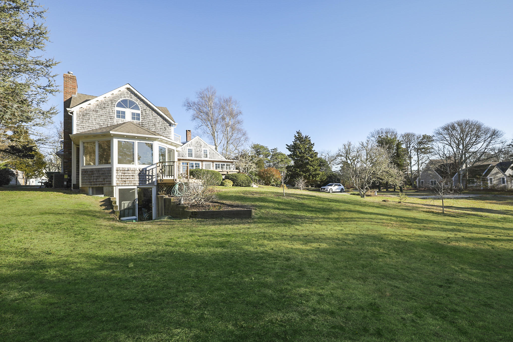 145 Barley Neck Road Orleans, MA 02653 - Photo 35 of 39 a front view of a house with a garden and trees