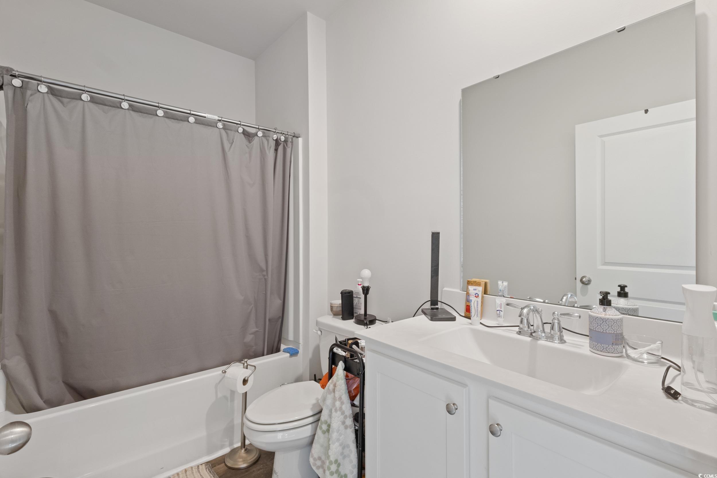 8034 Strudwick Drive Little River, SC 29566 - Photo 17 of 36 Full bath featuring vanity and shower / bath combination with curtain