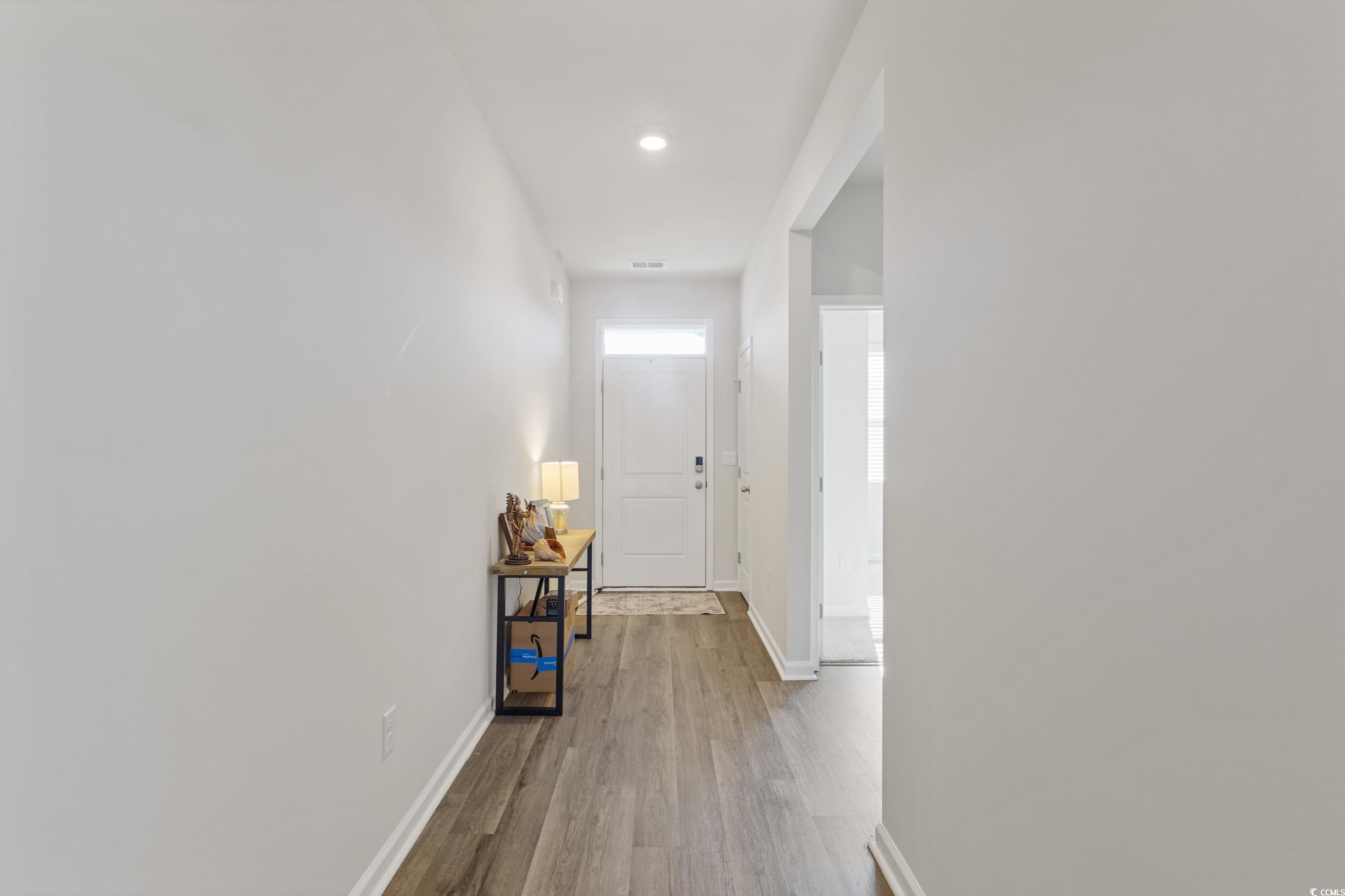 8034 Strudwick Drive Little River, SC 29566 - Photo 18 of 36 Corridor with light wood-type flooring and recessed lighting