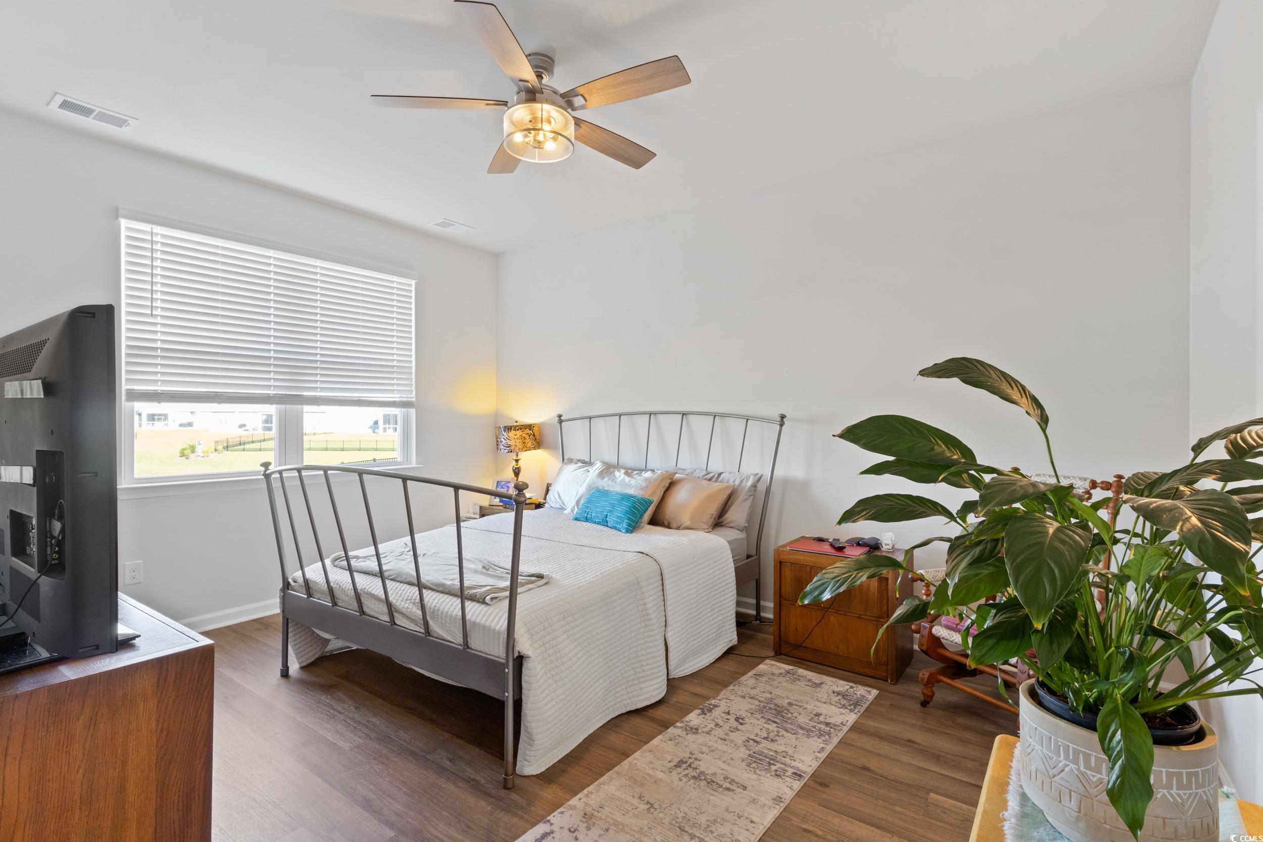 8034 Strudwick Drive Little River, SC 29566 - Photo 20 of 36 Bedroom with wood finished floors and a ceiling fan