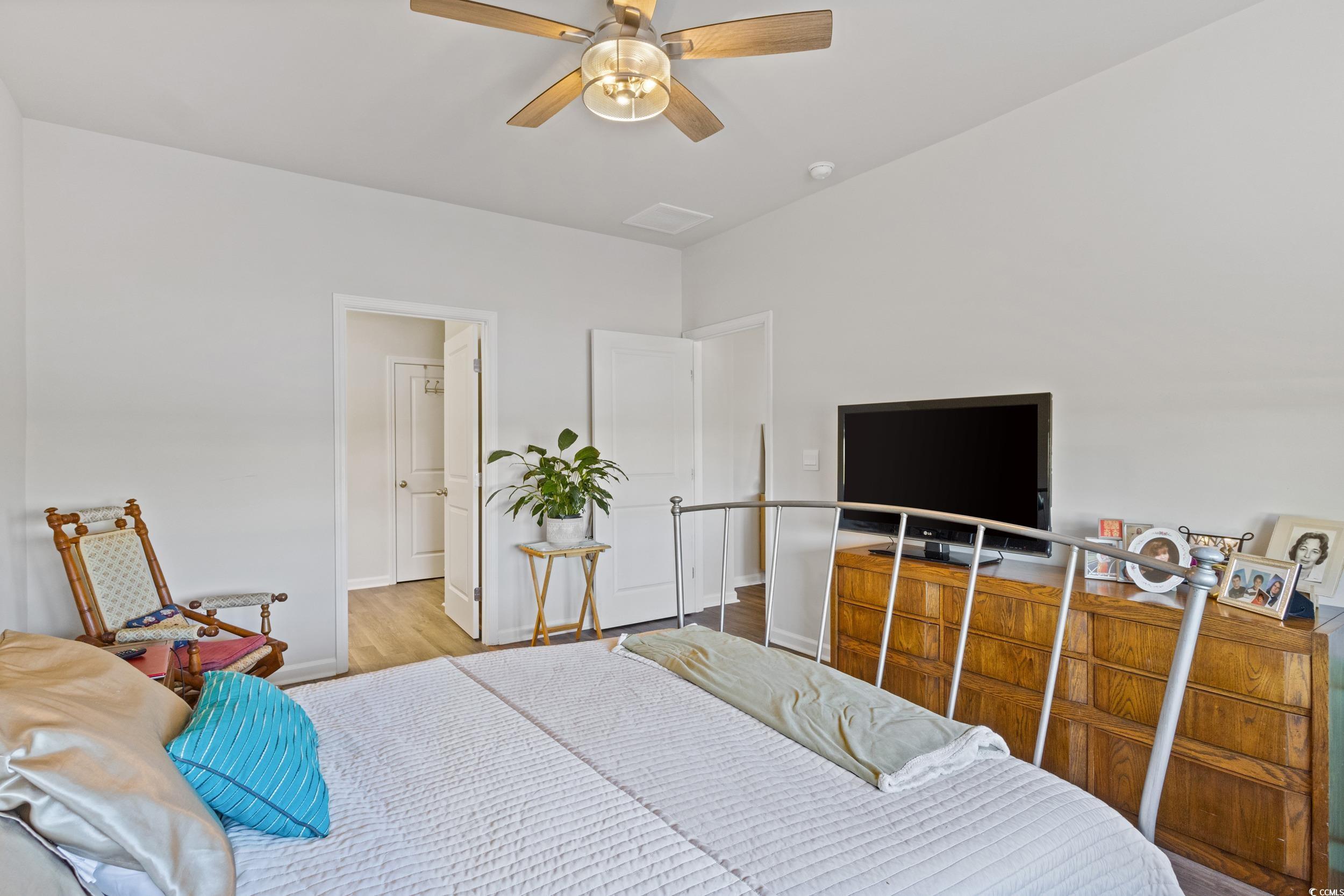 8034 Strudwick Drive Little River, SC 29566 - Photo 21 of 36 Bedroom featuring wood finished floors and a ceiling fan