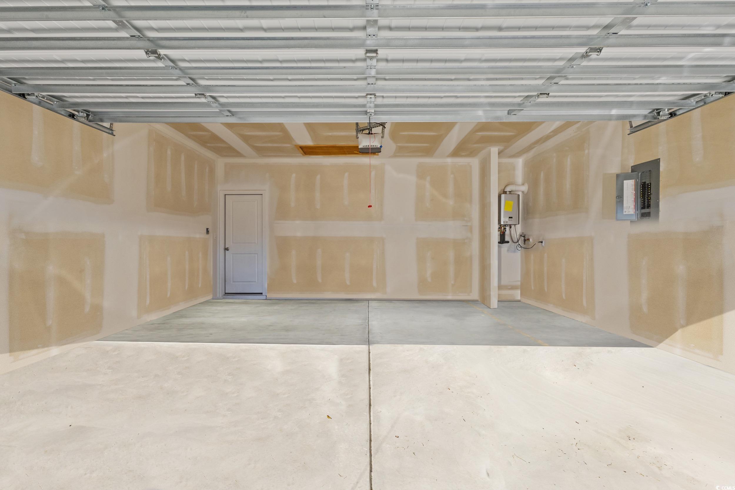 8034 Strudwick Drive Little River, SC 29566 - Photo 26 of 36 Garage with electric panel, tankless water heater, and a garage door opener