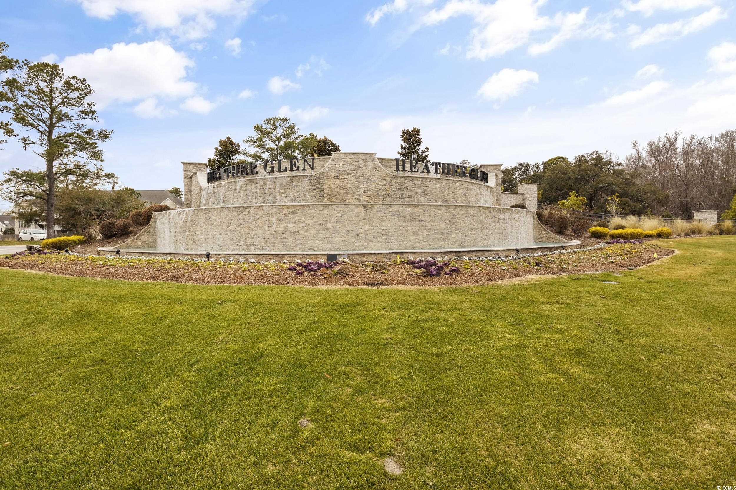 8034 Strudwick Drive Little River, SC 29566 - Photo 3 of 36 Community / neighborhood sign with a yard