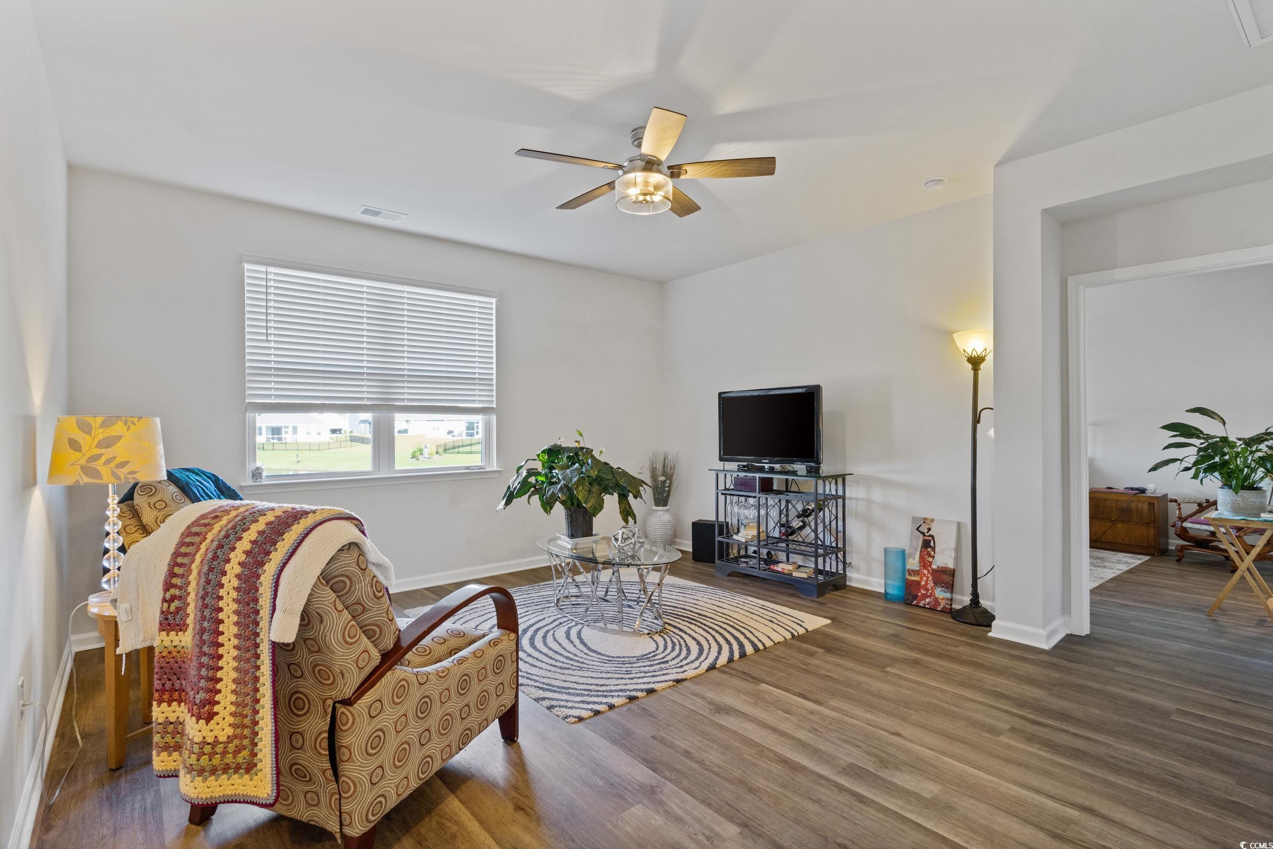 8034 Strudwick Drive Little River, SC 29566 - Photo 8 of 36 Living area featuring wood finished floors and ceiling fan
