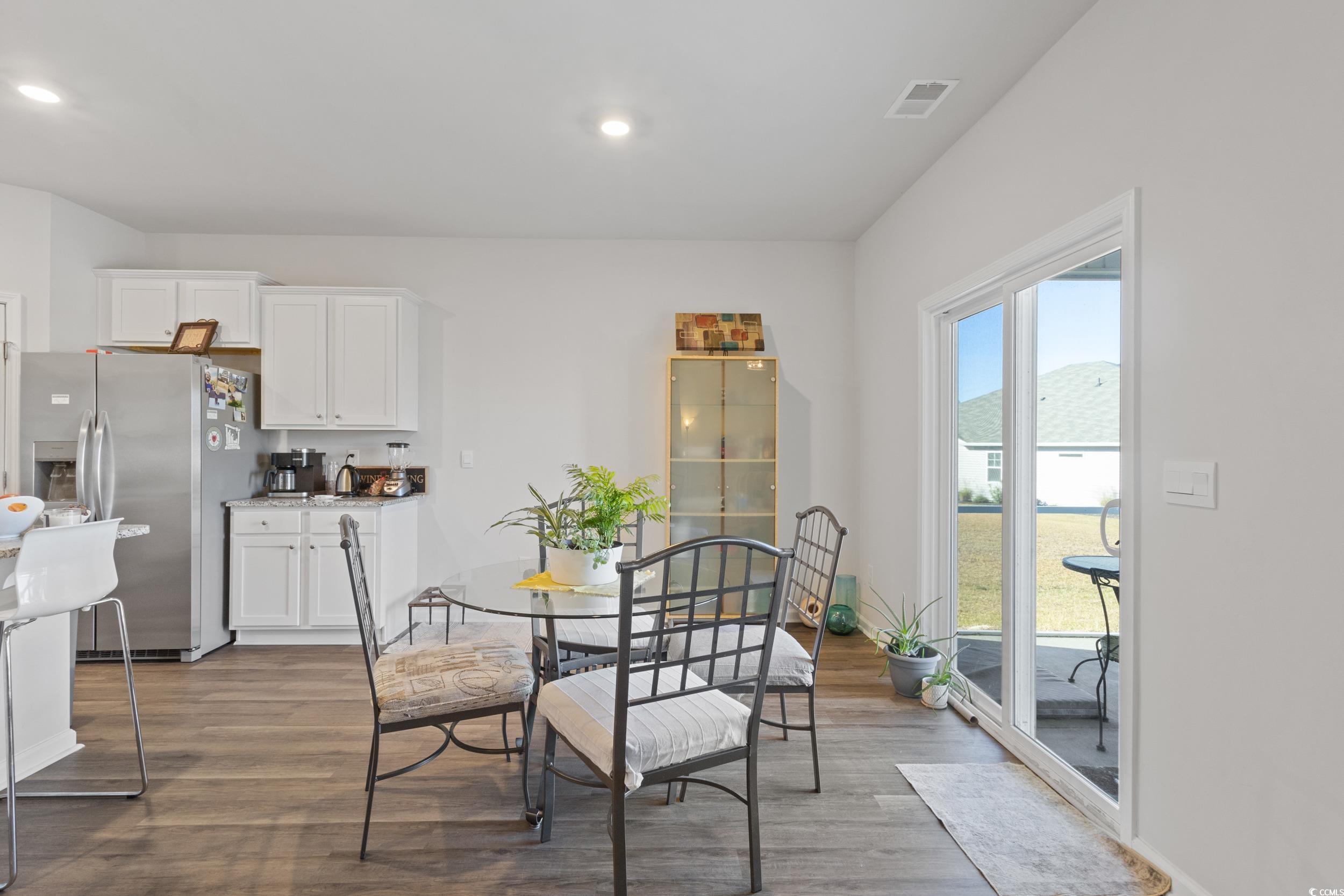 8034 Strudwick Drive Little River, SC 29566 - Photo 9 of 36 Dining space with dark wood finished floors and recessed lighting