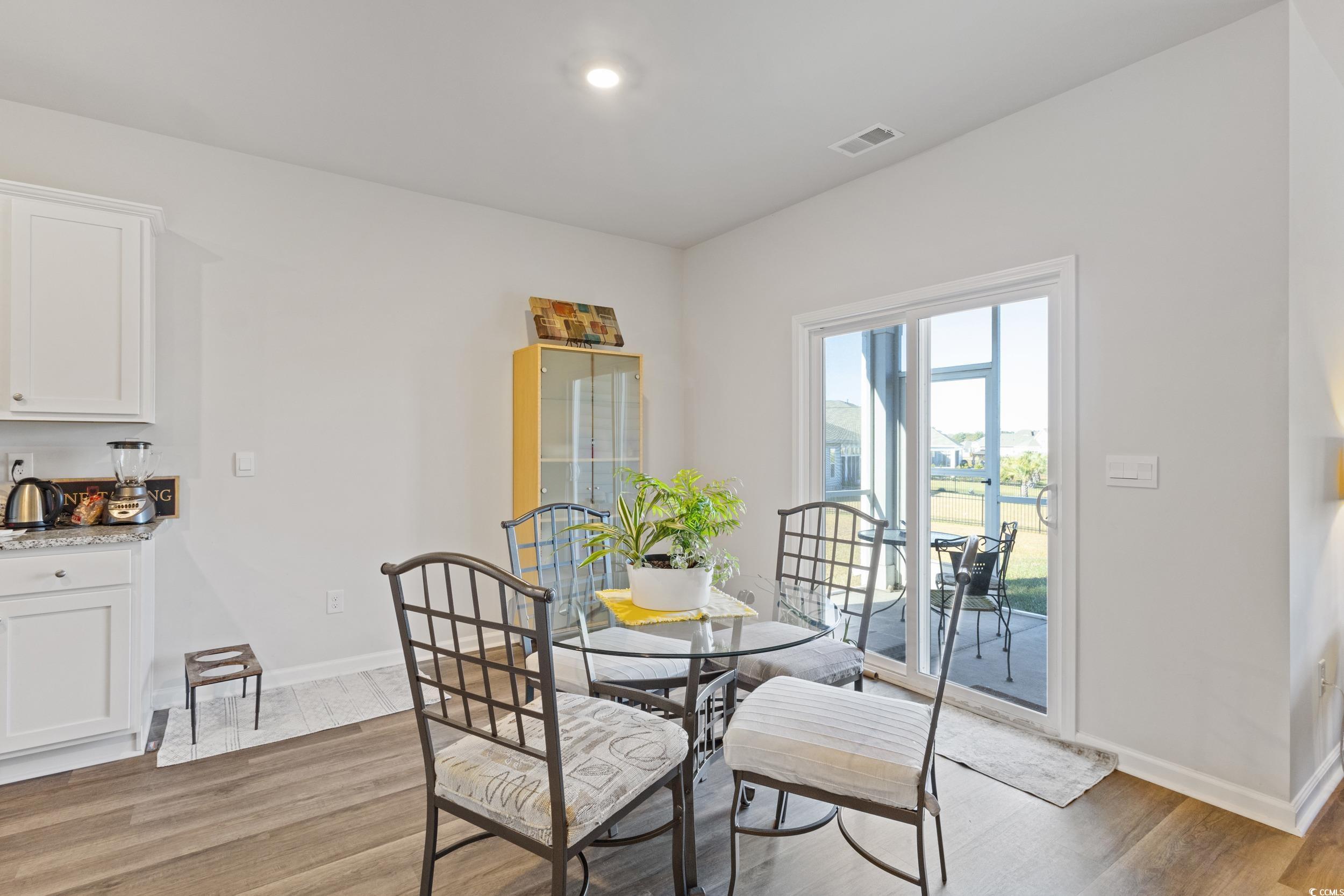 8034 Strudwick Drive Little River, SC 29566 - Photo 10 of 36 Dining space with light wood finished floors