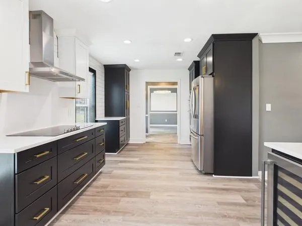 a kitchen with stainless steel appliances granite countertop a refrigerator and a sink