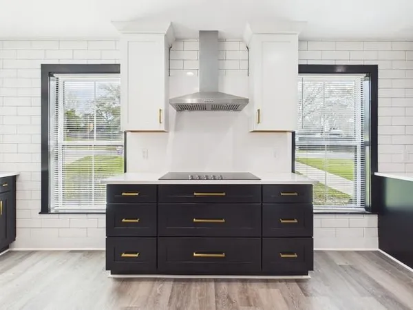 a kitchen with a wooden cabinets and a stove top oven