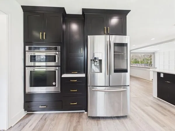 a kitchen with a refrigerator and microwave
