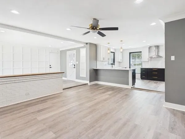 a view of a kitchen with wooden cabinet and a stove top oven