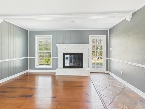 a view of a livingroom with an empty space and a fireplace