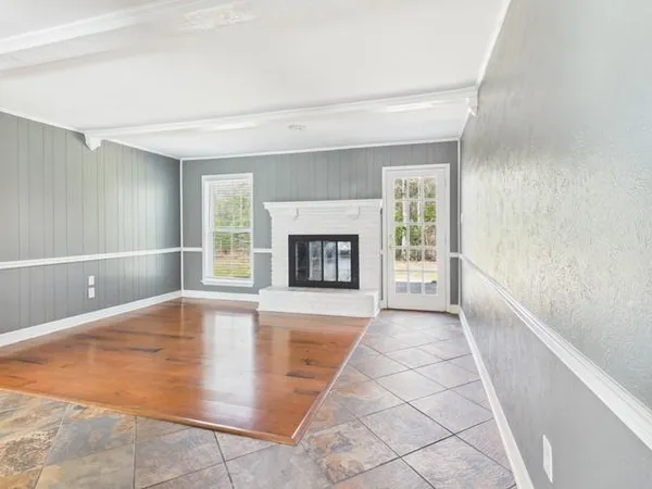 wooden floor in an empty room with a fireplace