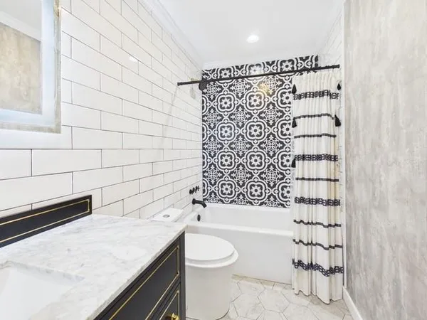 a bathroom with a shower toilet and sink