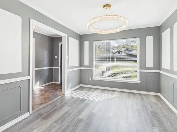 a view of wooden floor and a window in a room
