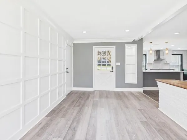 a view of an empty room with a kitchen