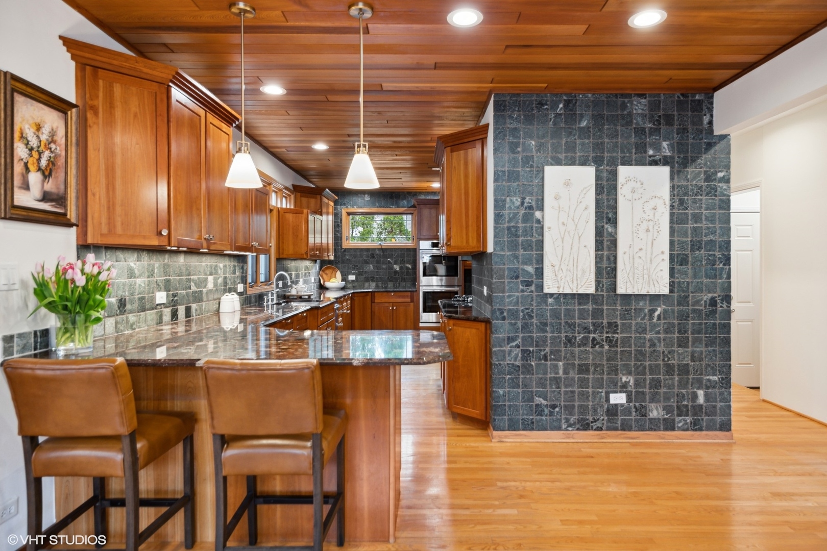 1939 Central Road Glenview, IL 60025 - Photo 11 of 34 a kitchen with stainless steel appliances kitchen island granite countertop a table chairs in it and wooden floor
