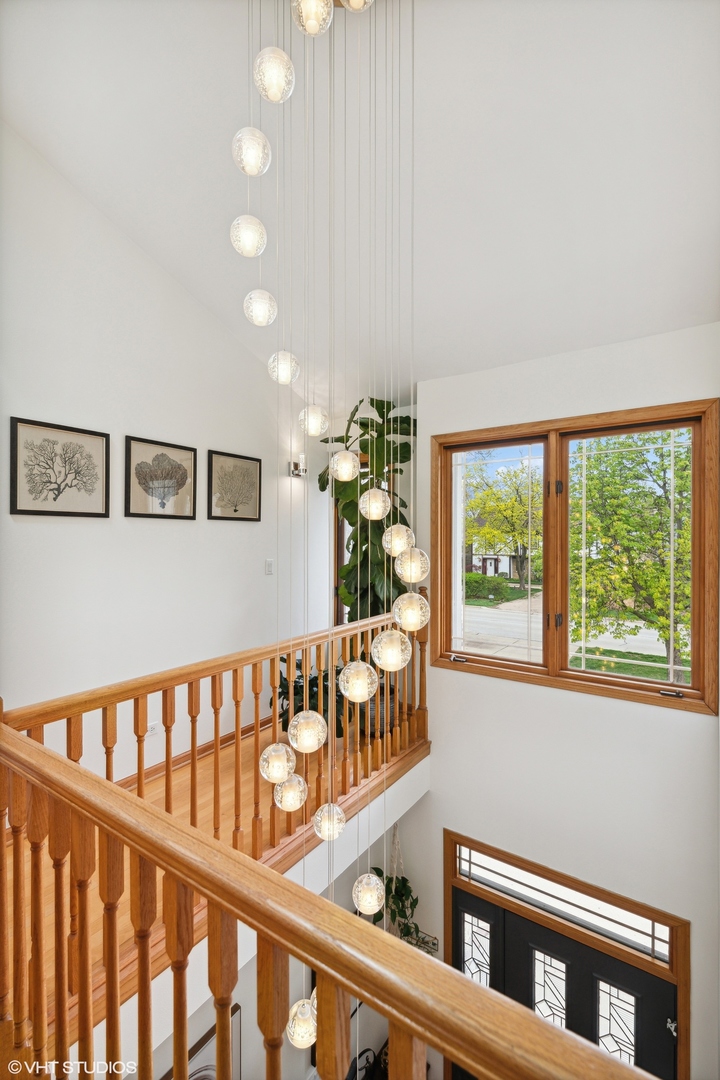 1939 Central Road Glenview, IL 60025 - Photo 18 of 34 a view of staircase with lots of frames on wall and a window