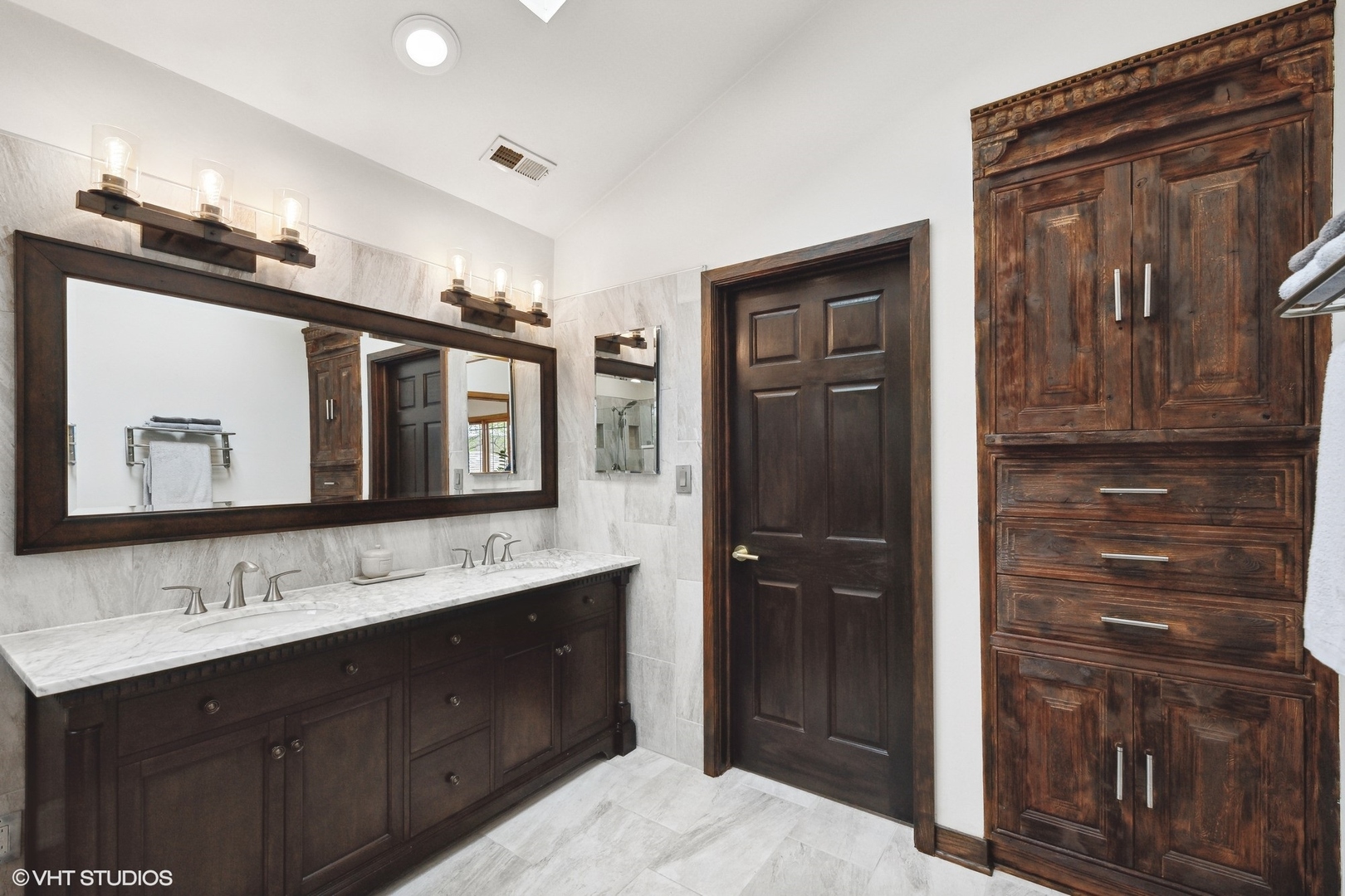 1939 Central Road Glenview, IL 60025 - Photo 20 of 34 a bathroom with a double vanity sink and mirror