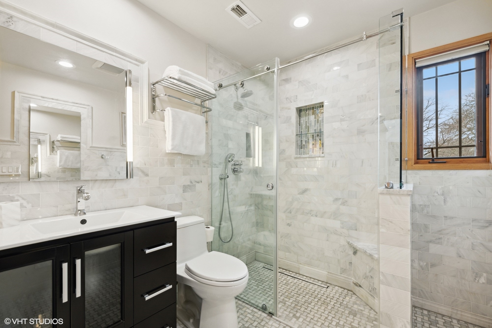 1939 Central Road Glenview, IL 60025 - Photo 24 of 34 a bathroom with a double vanity sink toilet and shower