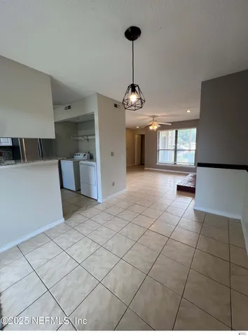 a view of a kitchen with a sink and chandelier