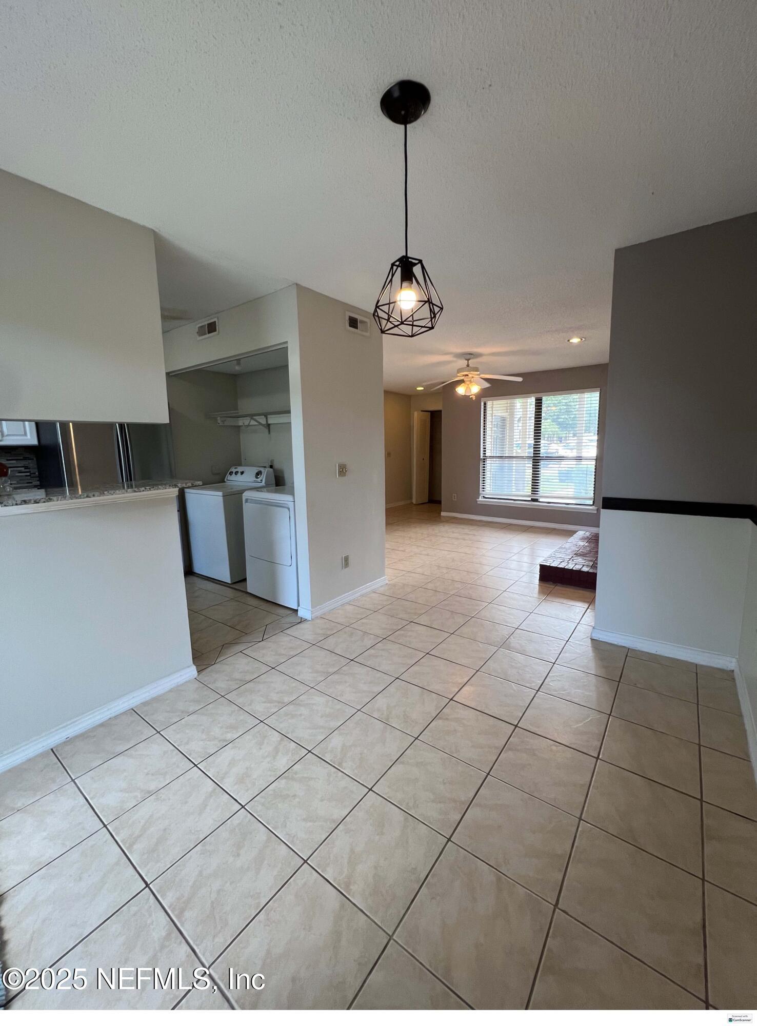 10200 Belle Rive Boulevard, Unit 83 Jacksonville, FL 32256 - Photo 18 of 21 a view of a kitchen with a sink and chandelier