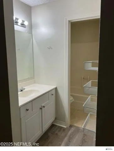 a bathroom with a shower and a sink