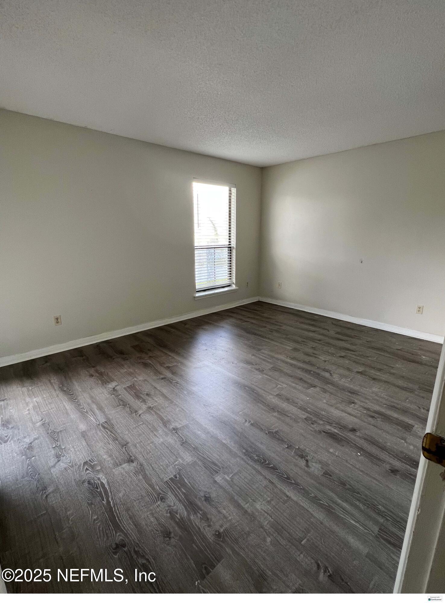 10200 Belle Rive Boulevard, Unit 83 Jacksonville, FL 32256 - Photo 7 of 21 an empty room with wooden floor and windows