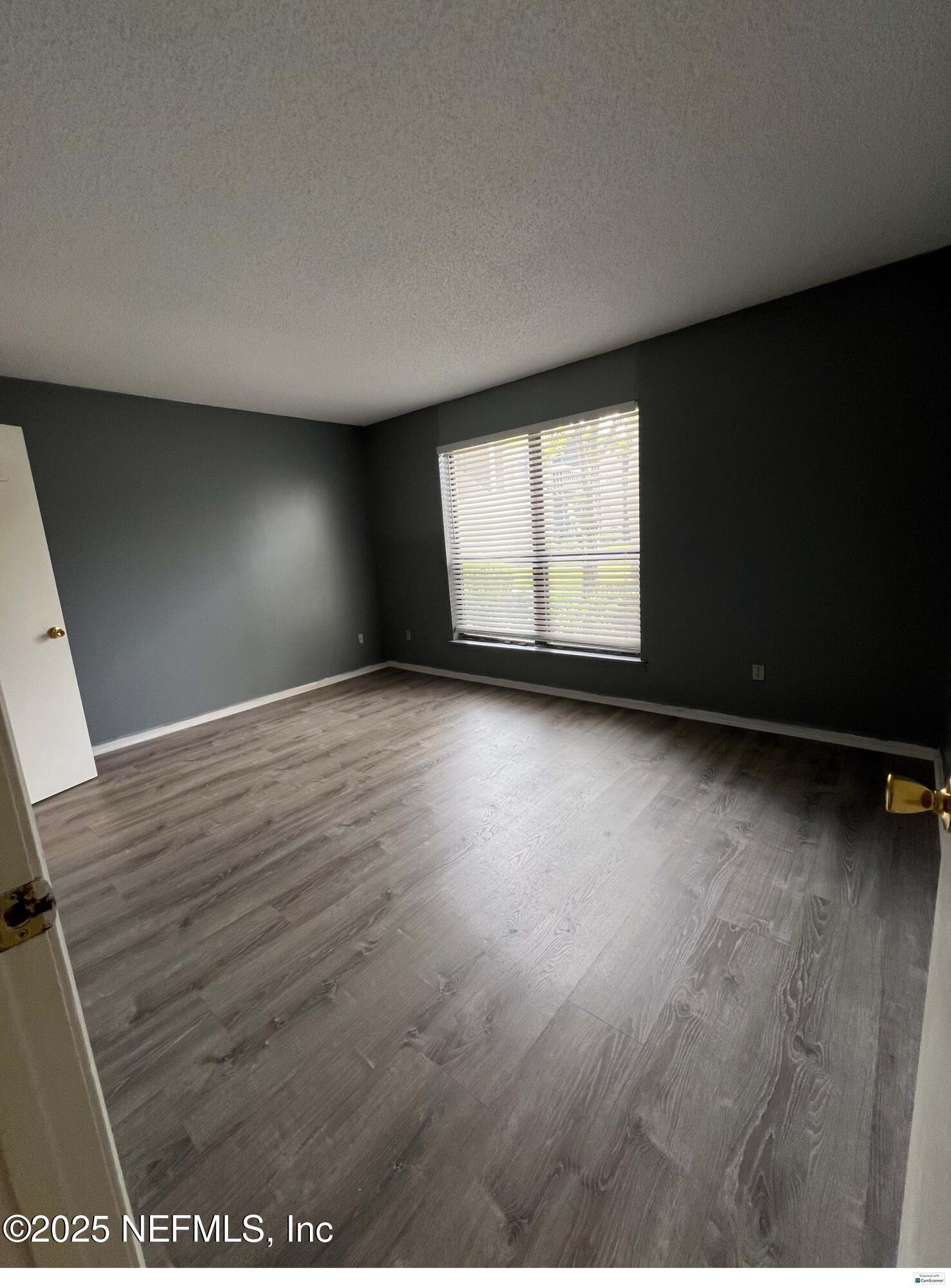 10200 Belle Rive Boulevard, Unit 83 Jacksonville, FL 32256 - Photo 8 of 21 an empty room with wooden floor and windows